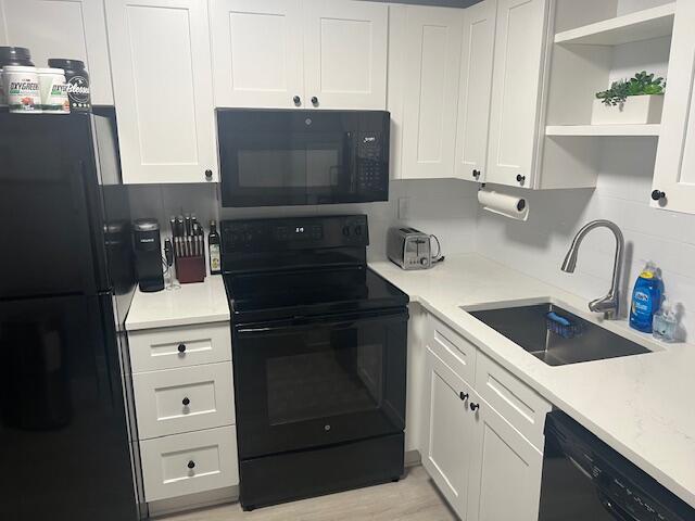 9440 Southwest 8th Street, Unit 417 Boca Raton, FL 33428 - Photo 6 of 21 a kitchen with a sink and cabinets