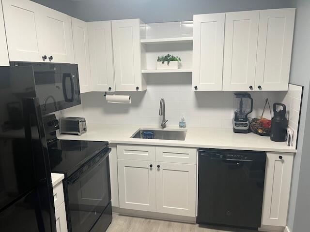 9440 Southwest 8th Street, Unit 417 Boca Raton, FL 33428 - Photo 7 of 21 a kitchen with a sink and cabinets