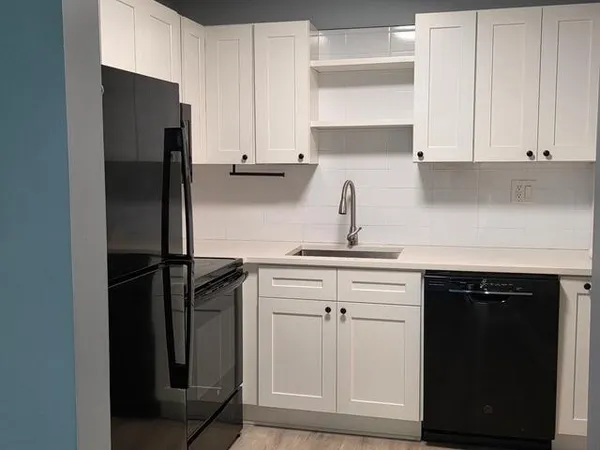 a kitchen with a refrigerator and cabinets