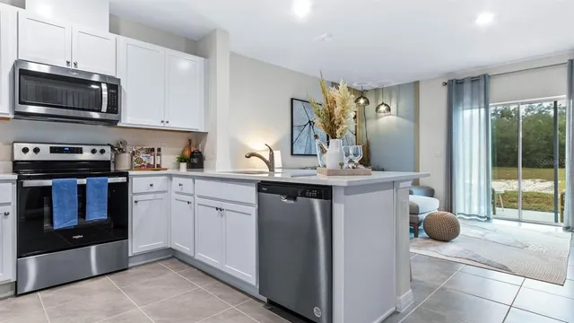 a kitchen with a sink and stainless steel appliances