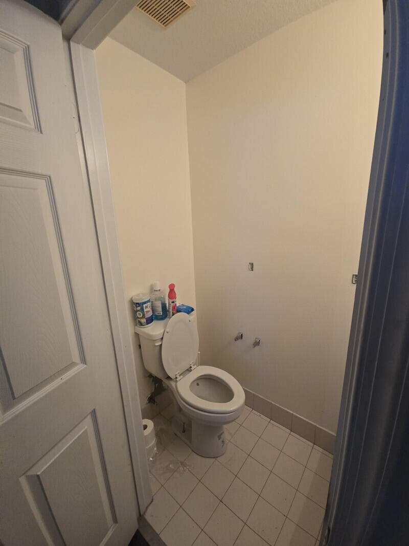 6511 Sandy Bank Terrace Riviera Beach, FL 33407 - Photo 12 of 12 a white toilet sitting next to a sink