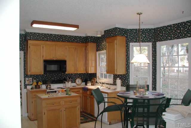 4432 Pike Road Raleigh, NC 27613 - Photo 4 of 10 a dining hall with furniture a window and a fireplace