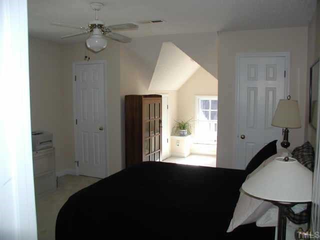 4432 Pike Road Raleigh, NC 27613 - Photo 7 of 10 a bedroom with a bed window and lamp