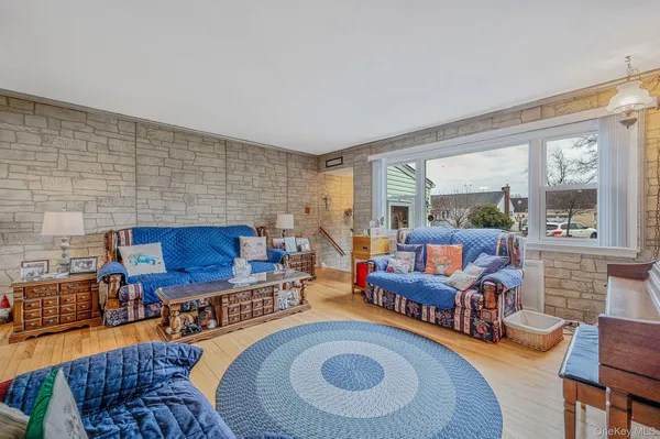 a living room with fireplace furniture and a large window