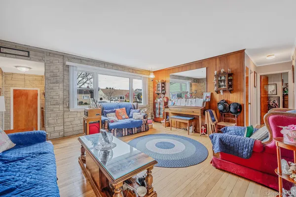 a living room with furniture and a floor to ceiling window