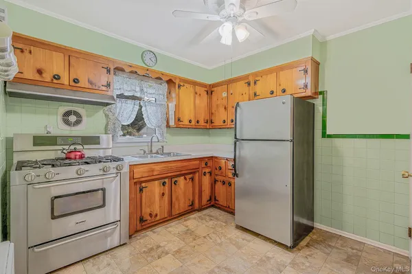 a kitchen with stainless steel appliances granite countertop a refrigerator and a stove top oven