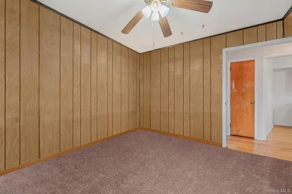 a view of a big room with wooden walls