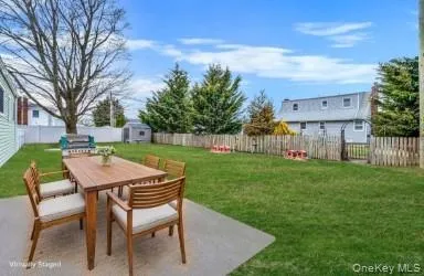 a backyard of a house with table and chairs