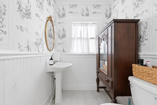 a bathroom with a sink a mirror and a window