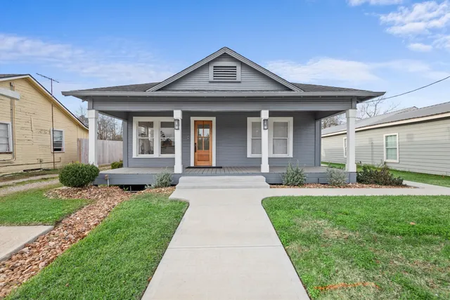 a front view of a house with a yard and porch