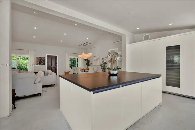 a kitchen with stainless steel appliances granite countertop a sink and a refrigerator