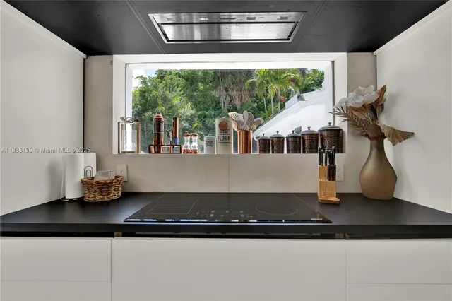 a kitchen with a sink and a large window