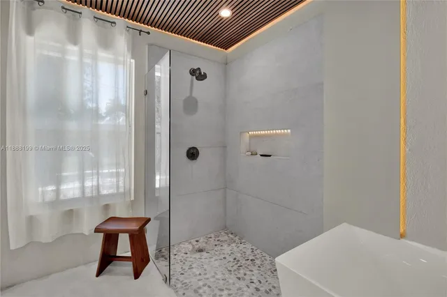 a bathroom with a tub and shower