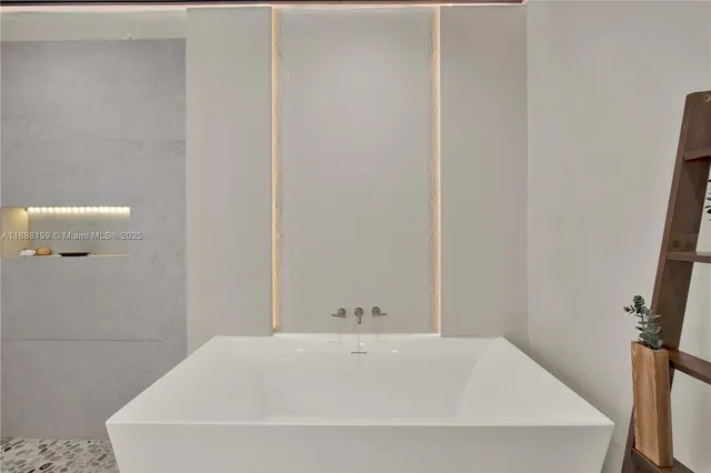 a white bath tub sitting in a bathroom