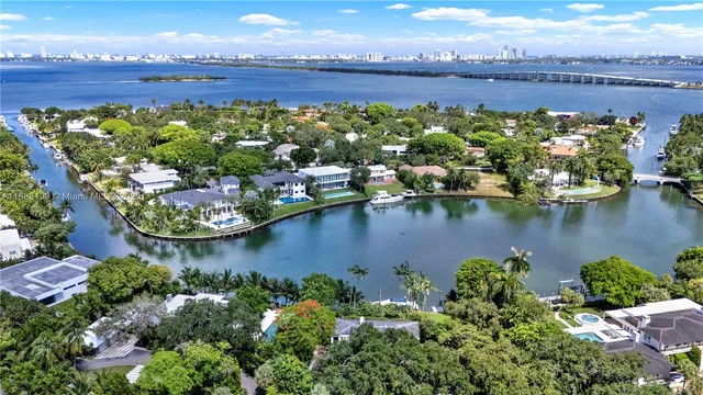 an aerial view of a house with a garden and lake view