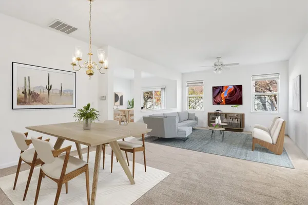 a view of a dining room with furniture a livingroom and wooden floor