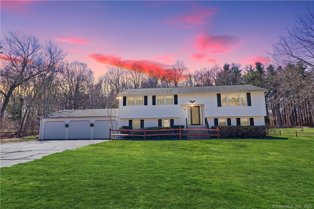 9 Blue Trail Drive Prospect, CT 06712 - Photo 1 of 1 a front view of a house with a garden and a yard