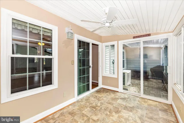a bedroom with a large bed a chandelier and a window