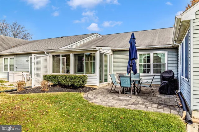 a front view of a house with swimming pool and porch