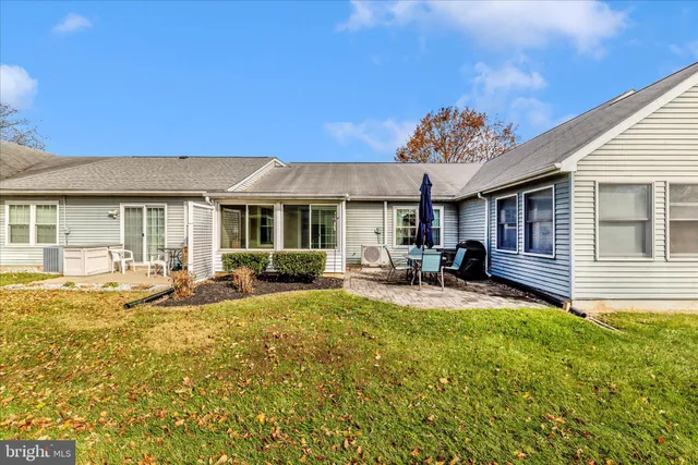 a view of a house with backyard porch and sitting area