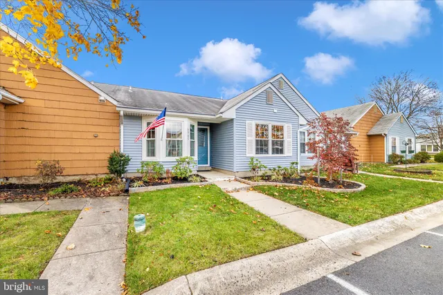 a view of a house with a big yard and large trees