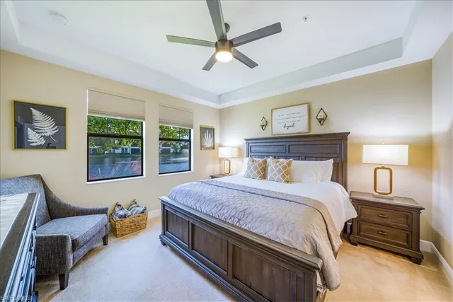 a bedroom with a bed a couch and a large window