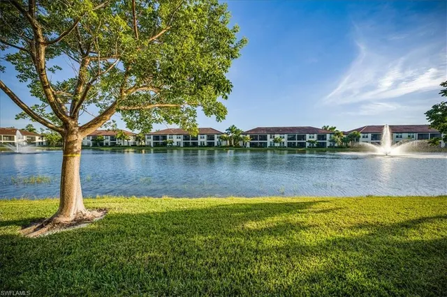 a view of a lake with houses in the back