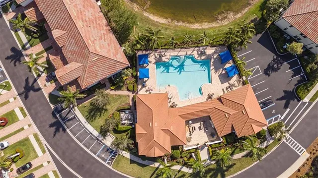 an aerial view of a house with a yard and potted plants
