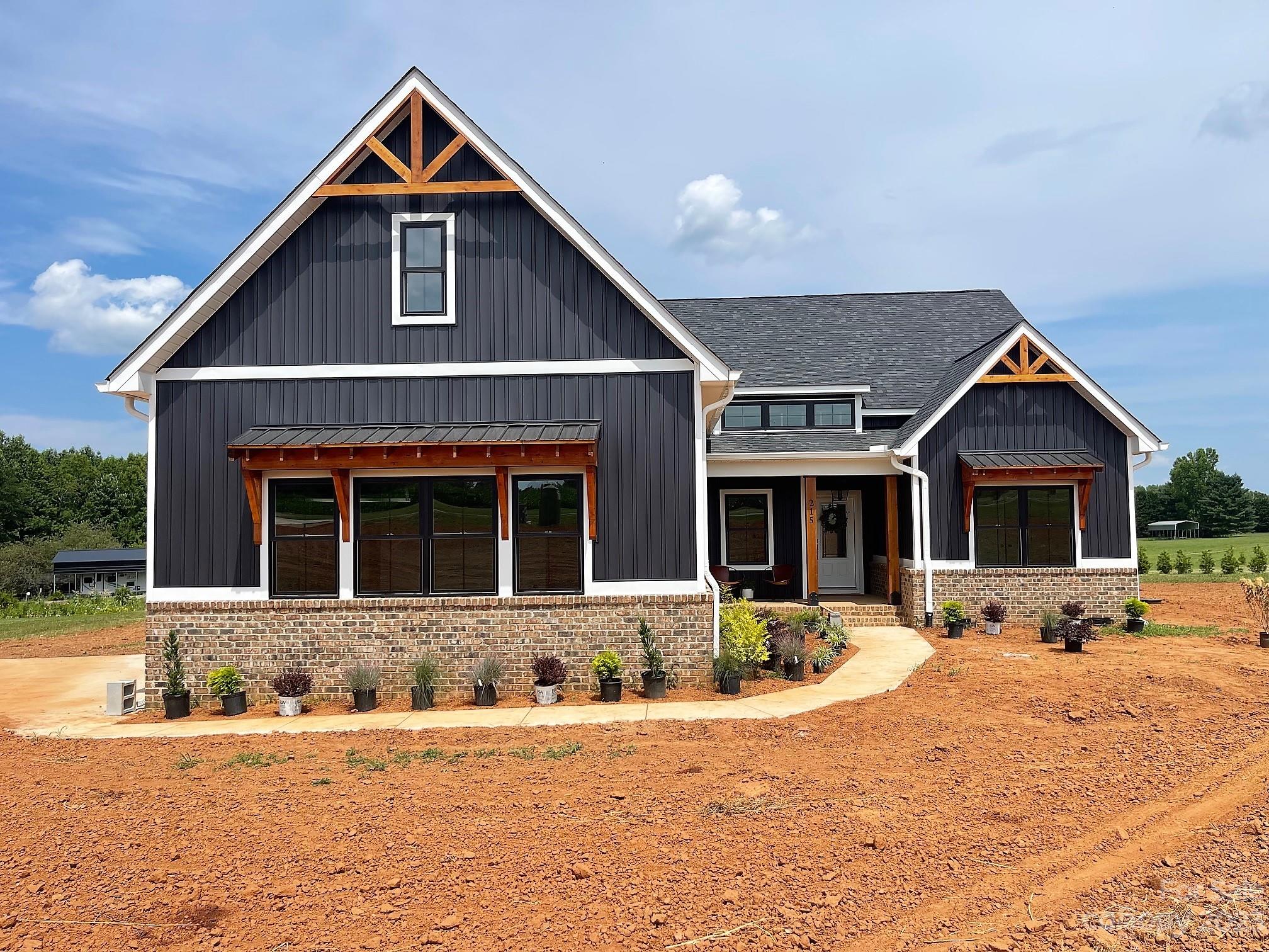215 Cal Kennedy Road Cleveland, NC 27013 - Photo 1 of 39 a front view of a house with a yard