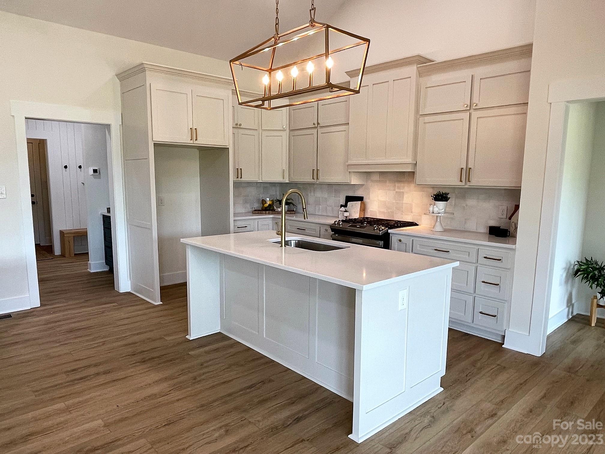 215 Cal Kennedy Road Cleveland, NC 27013 - Photo 16 of 39 a kitchen with white cabinets and stainless steel appliances