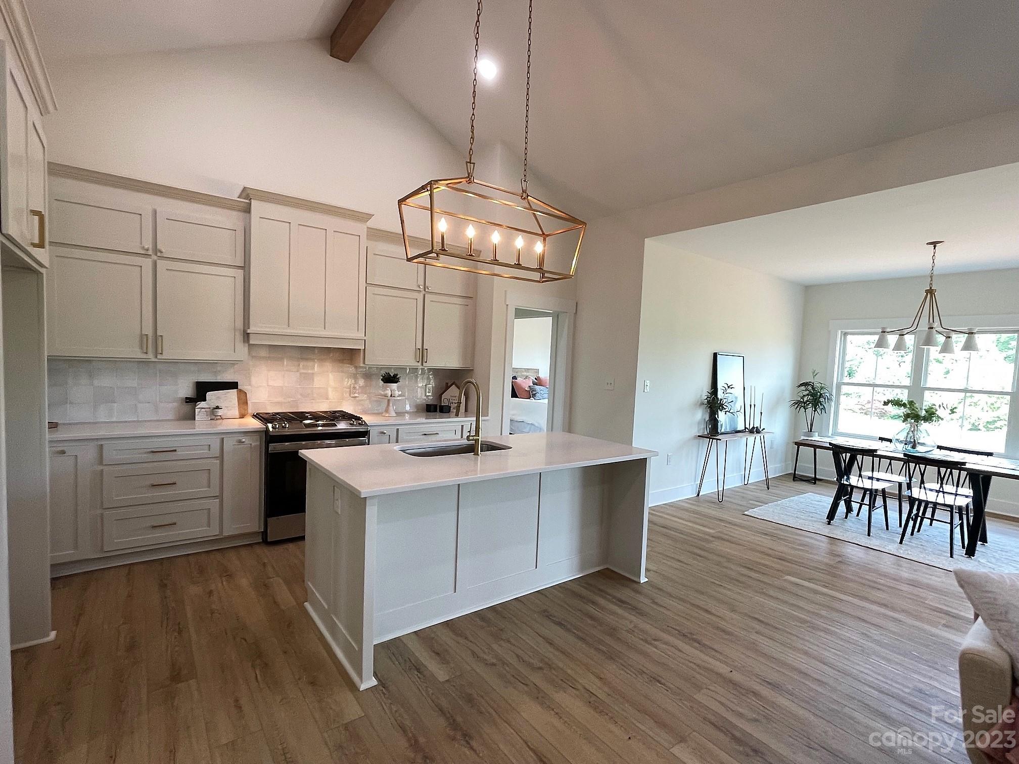 215 Cal Kennedy Road Cleveland, NC 27013 - Photo 17 of 39 a large kitchen with cabinets wooden floor and stainless steel appliances