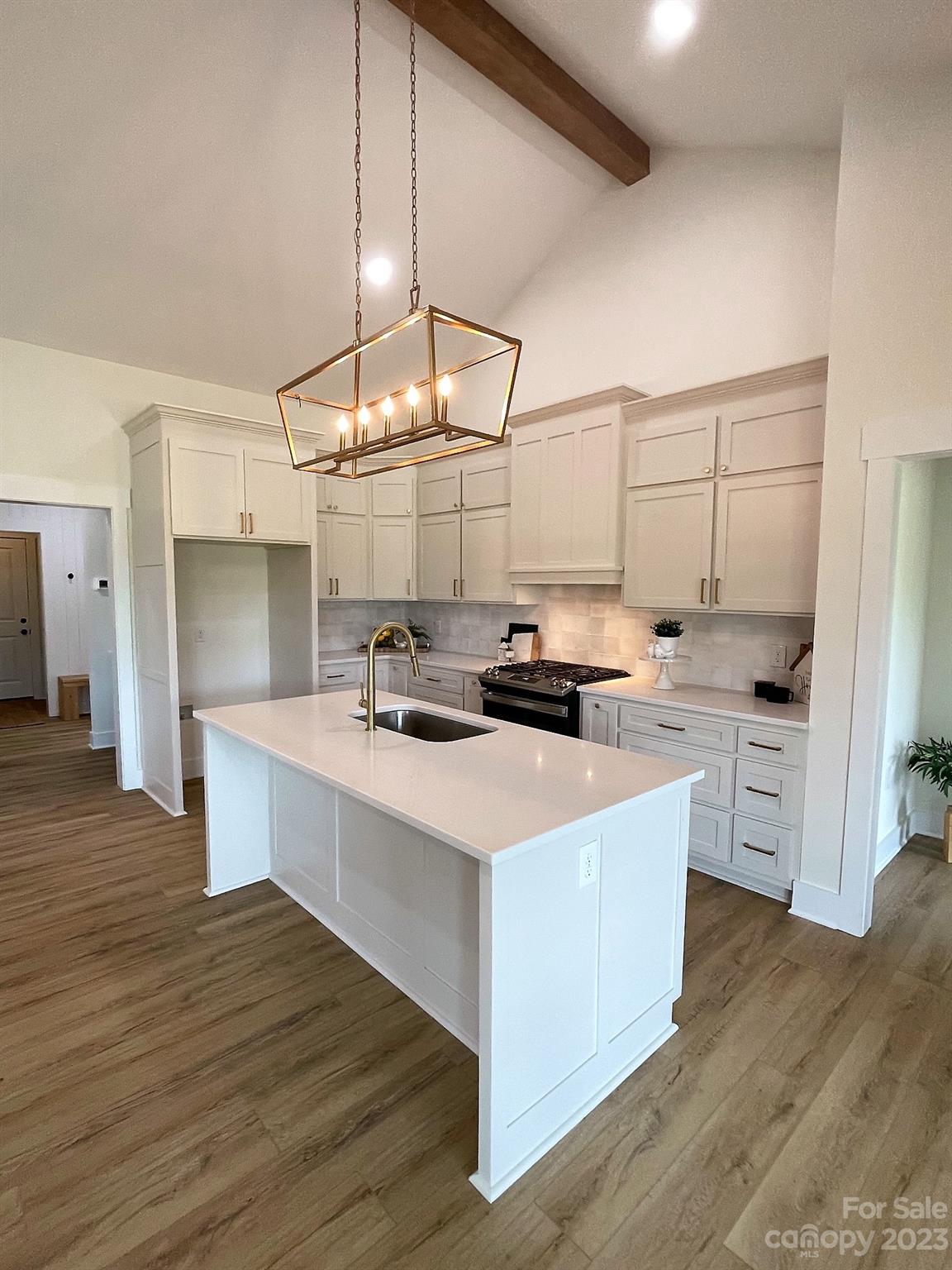 215 Cal Kennedy Road Cleveland, NC 27013 - Photo 18 of 39 a kitchen with kitchen island stainless steel appliances a sink a counter top space and cabinets