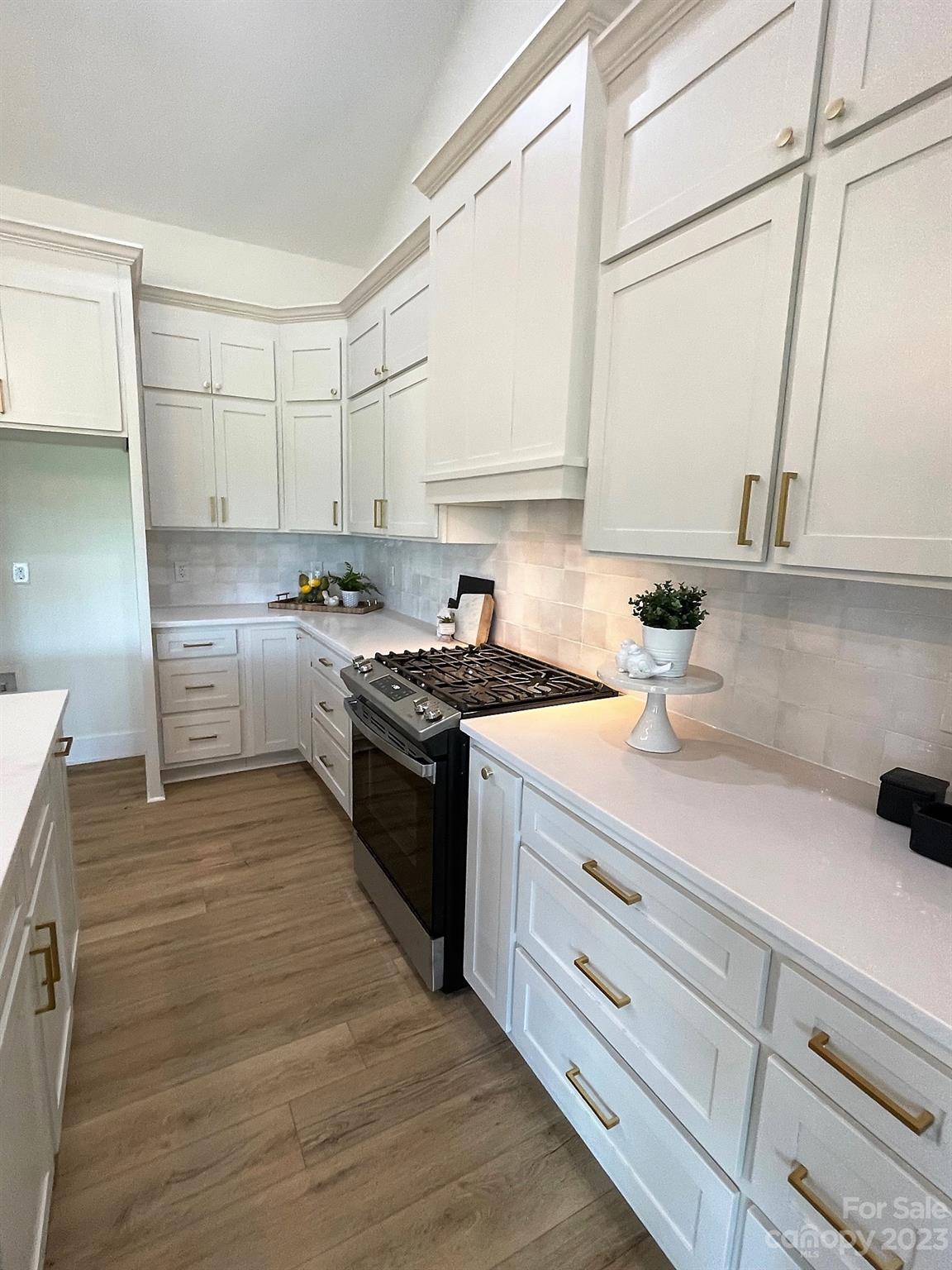215 Cal Kennedy Road Cleveland, NC 27013 - Photo 20 of 39 a kitchen with stainless steel appliances granite countertop a sink stove and cabinets