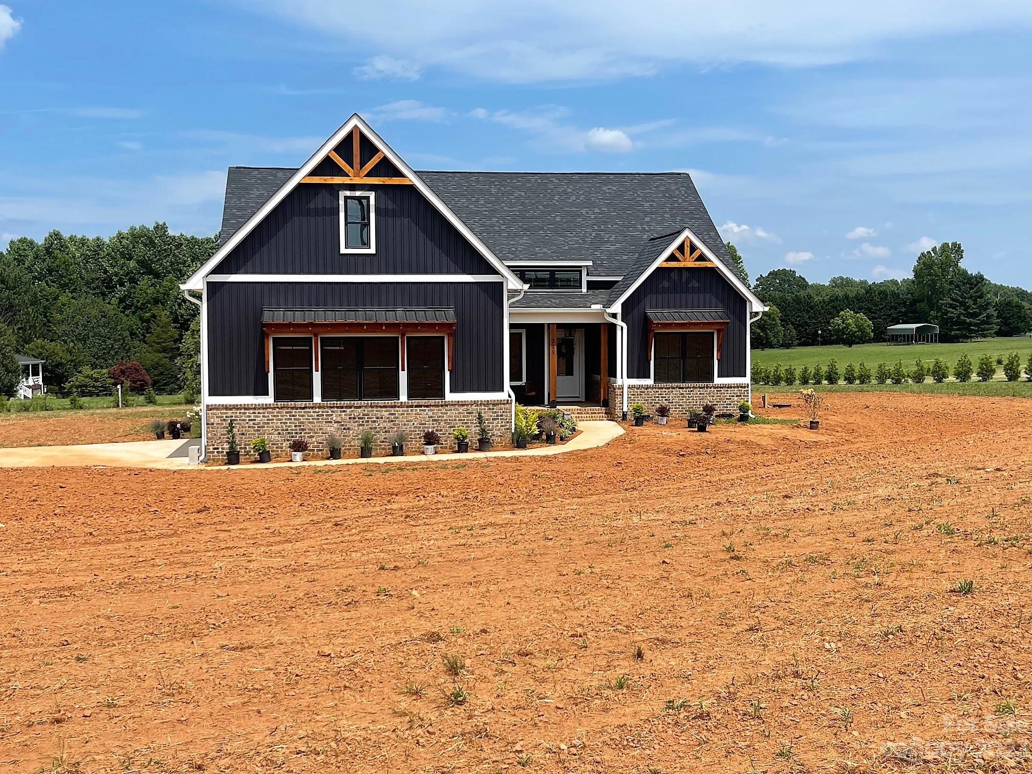 215 Cal Kennedy Road Cleveland, NC 27013 - Photo 2 of 39 a front view of a house with swimming pool