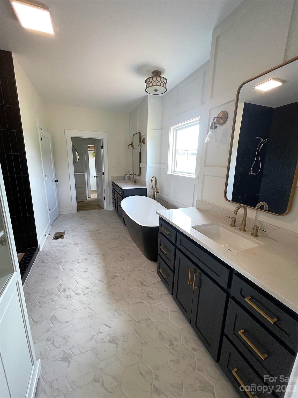 215 Cal Kennedy Road Cleveland, NC 27013 - Photo 30 of 39 a spacious bathroom with a double vanity sink and a mirror