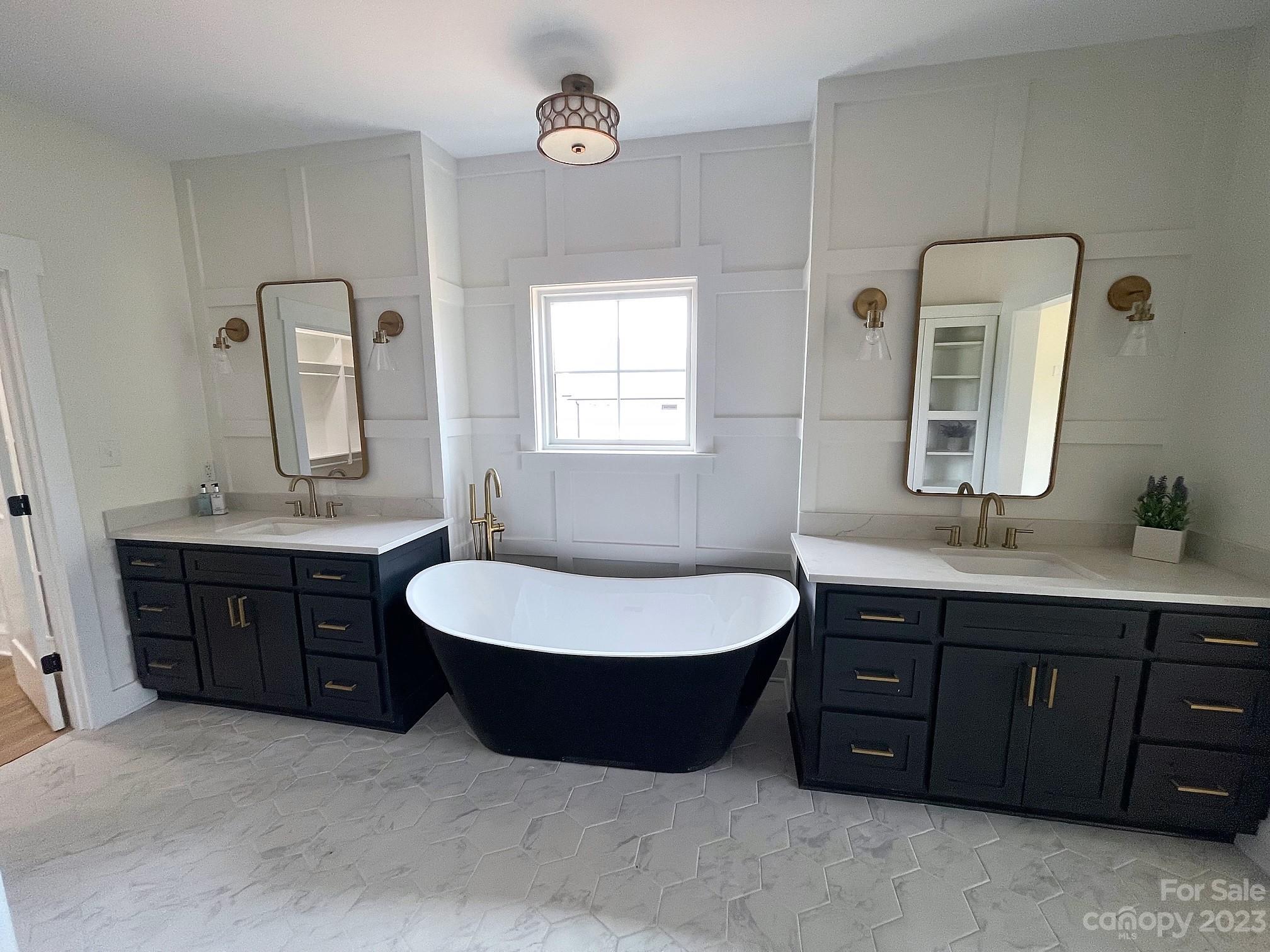 215 Cal Kennedy Road Cleveland, NC 27013 - Photo 31 of 39 a bathroom with a double vanity sink mirror and bathtub