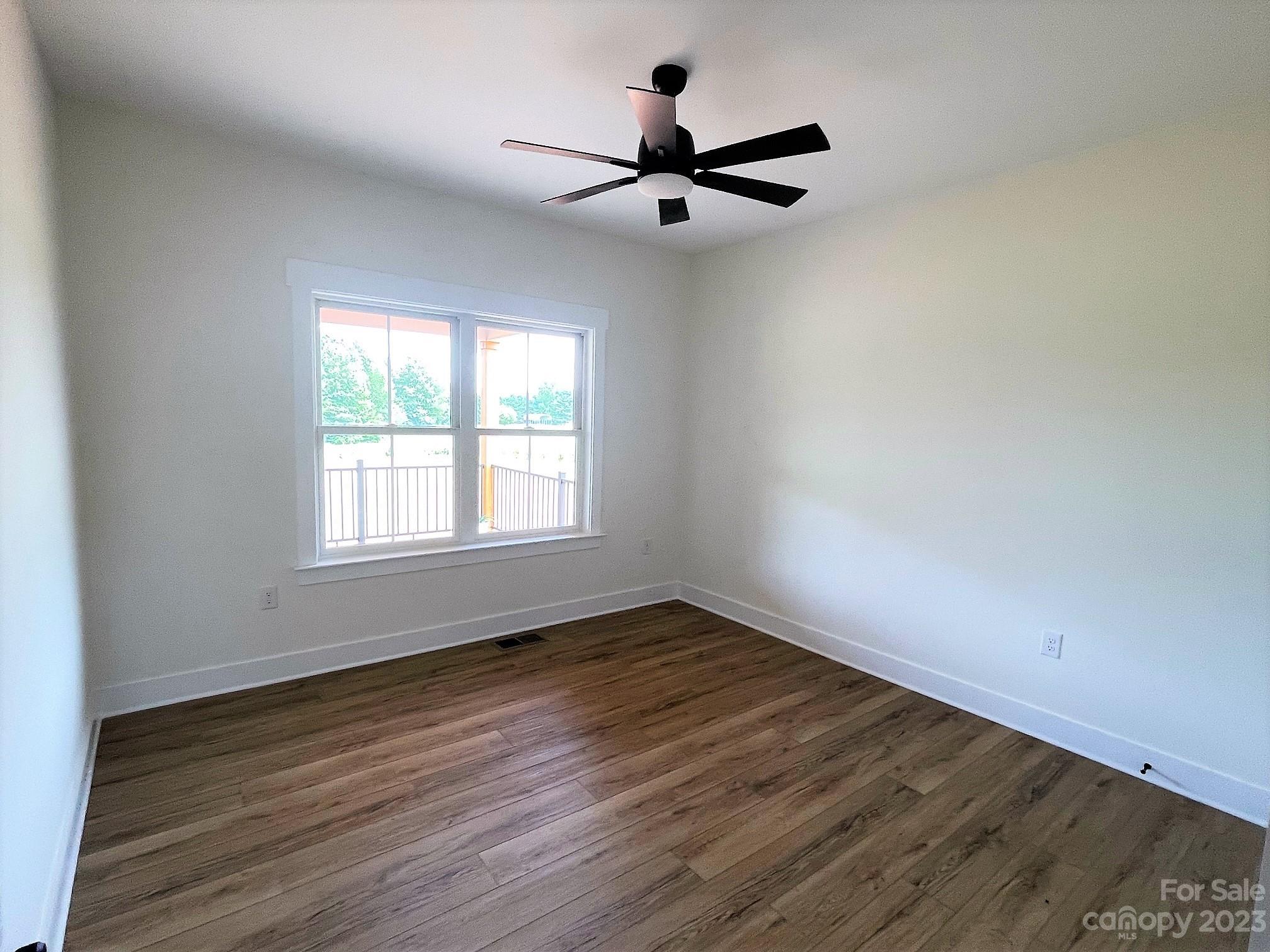 215 Cal Kennedy Road Cleveland, NC 27013 - Photo 35 of 39 a view of an empty room with wooden floor and a window