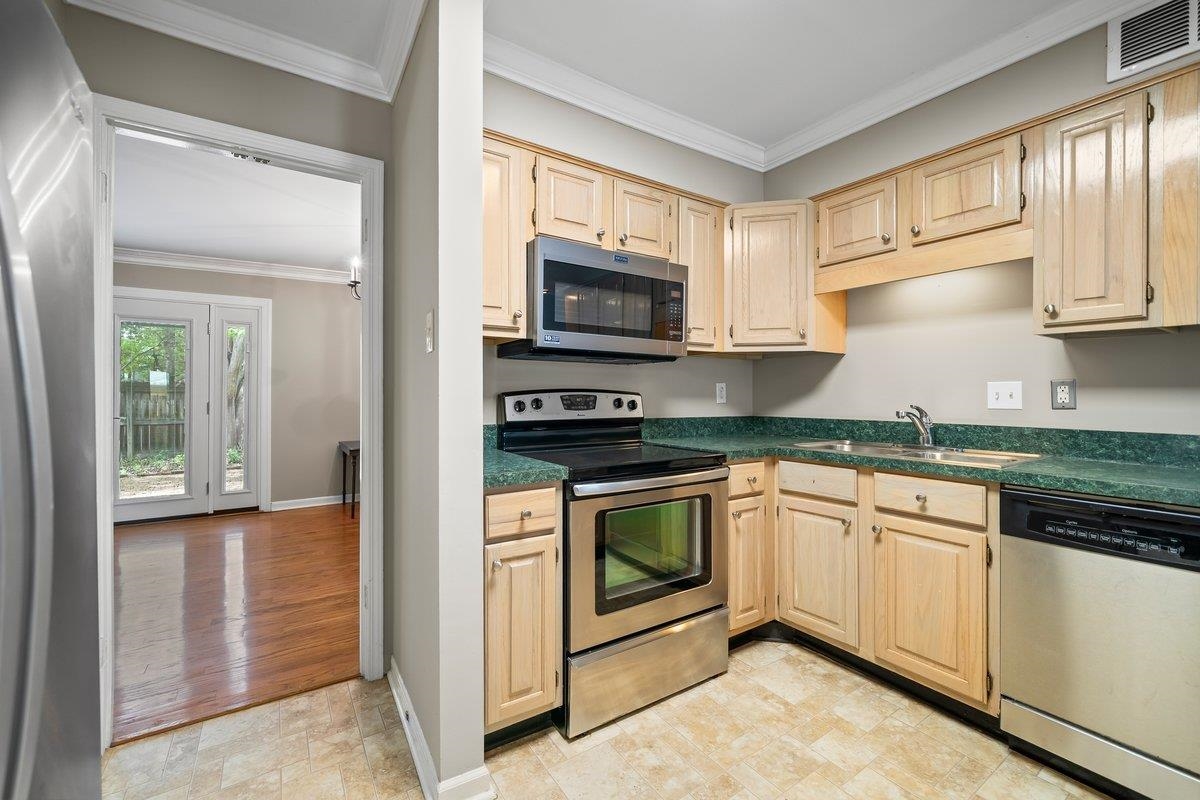 6942 Amberly Road, Unit 6942 Memphis, TN 38119 - Photo 6 of 23 a kitchen with granite countertop a stove top oven microwave and cabinets