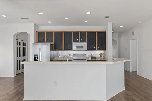 a kitchen that has a sink and a stove