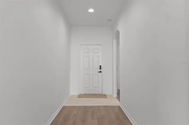 a view of a hallway with wooden floor