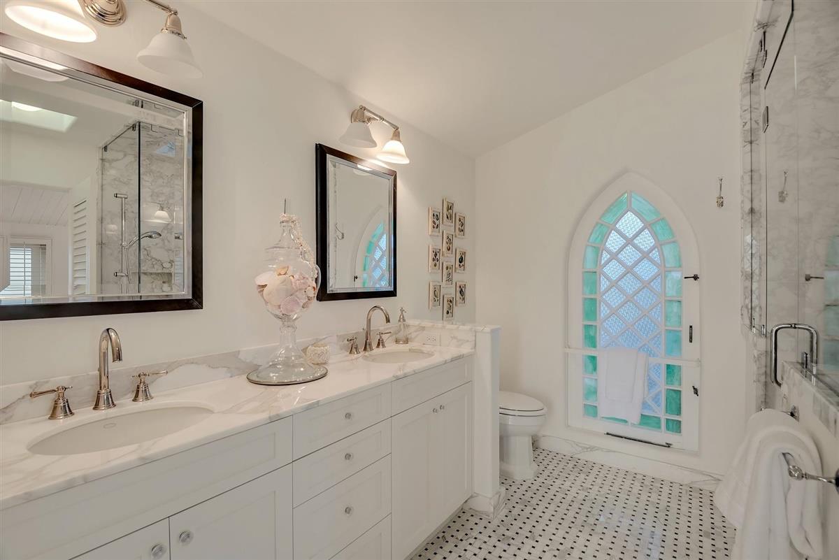 759 Las Olas Drive Aptos, CA 95003 - Photo 32 of 50 a bathroom with a double vanity sink a toilet and a mirror