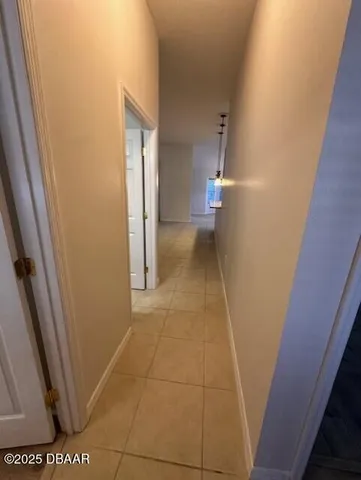 a view of a hallway to rooms