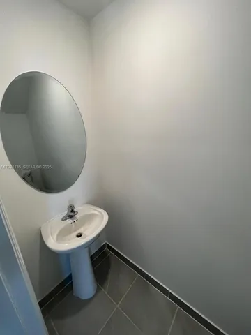 a bathroom with a sink and mirror