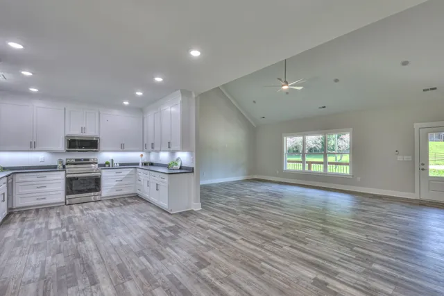 a kitchen with a white stove top oven and cabinets