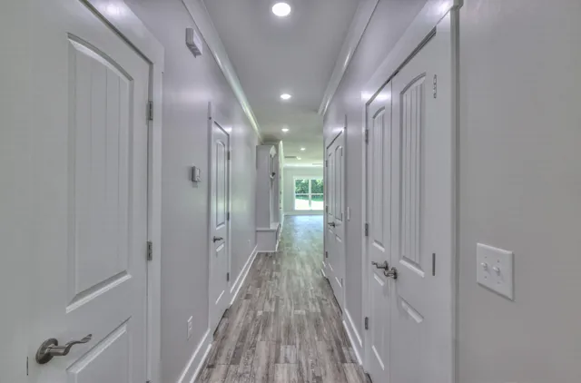 a kitchen with a sink stainless steel appliances cabinets and a window