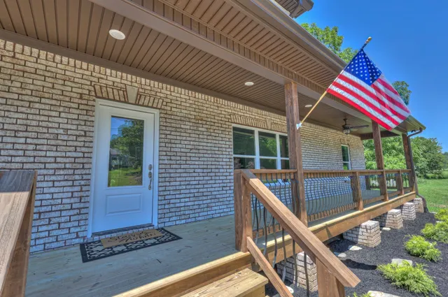 a view of a room with wooden floor and iron stairs