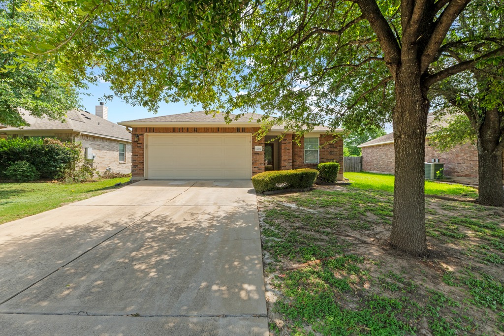 12008 Lansdowne Road Austin, TX 78754 - Photo 2 of 29 Mature trees shade this charming brick residence with an attached garage.