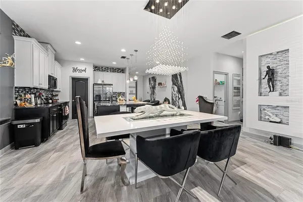 a view of a kitchen and dining area with chandelier