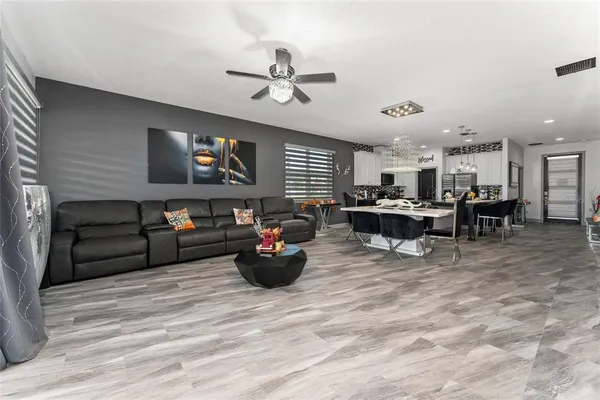a living room with furniture and a chandelier