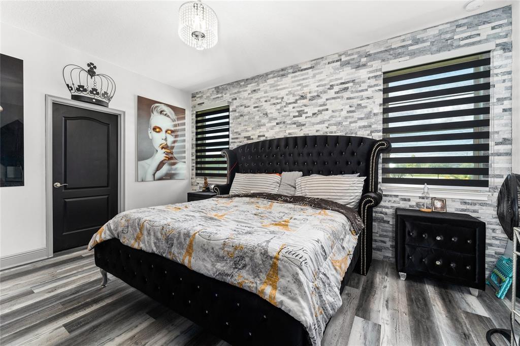 3199 Crispin Circle Harmony, FL 34773 - Photo 14 of 37 a bedroom with a bed and a fireplace